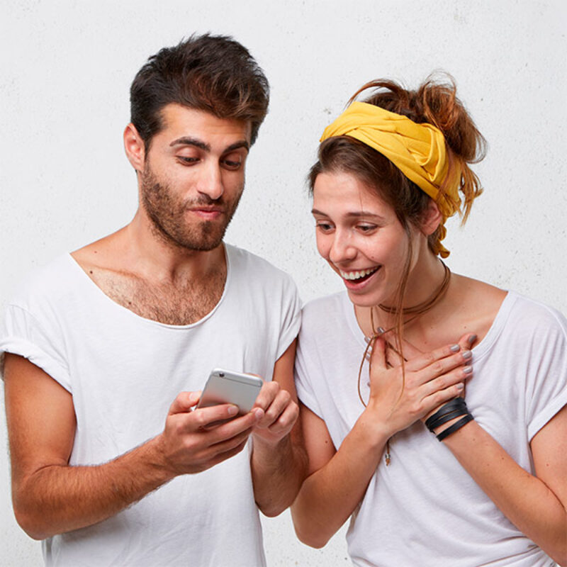 Two people watching phone